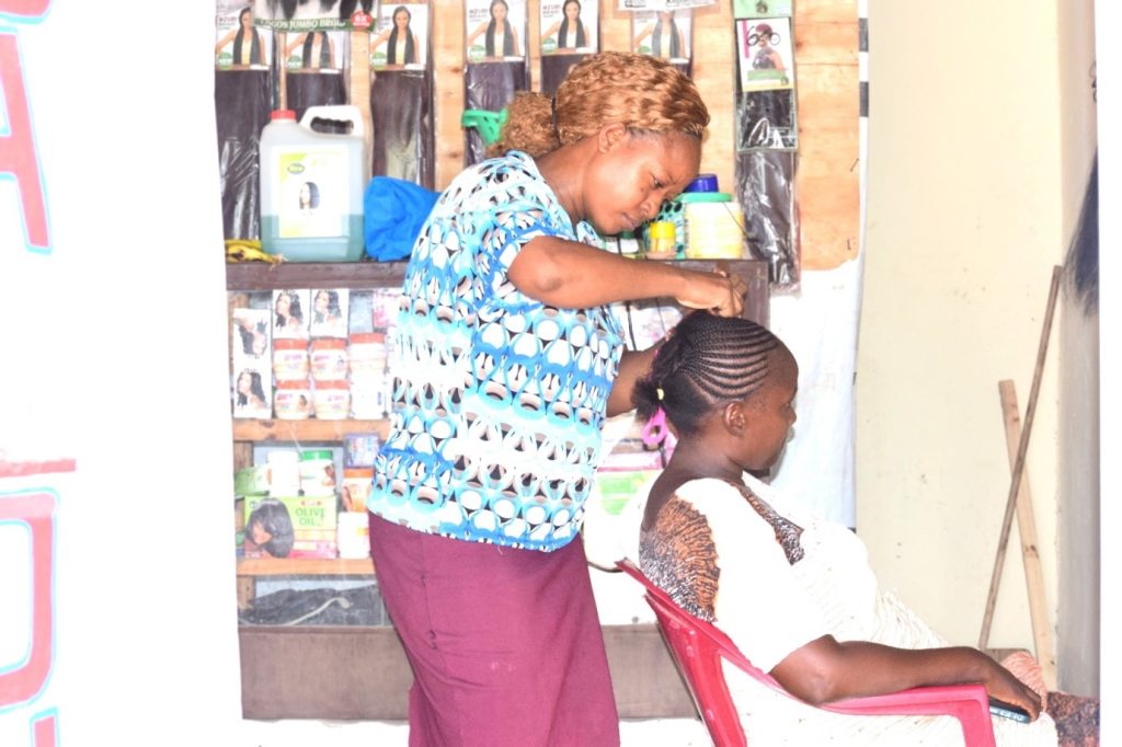 Project participant with her client, at her salon, during the impact monitoring mission at Madogo Center, Tana River on 31st January, 2025. Photo Credit: RCK, Elijah Bosco Magaiwa